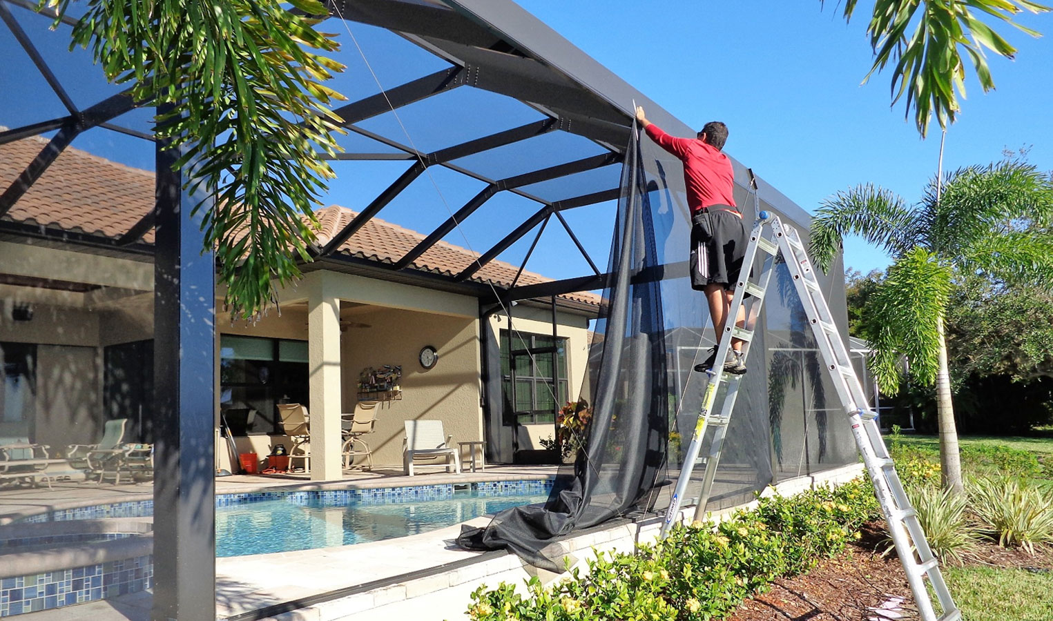 Lanai screen repair technician replacing screen panels